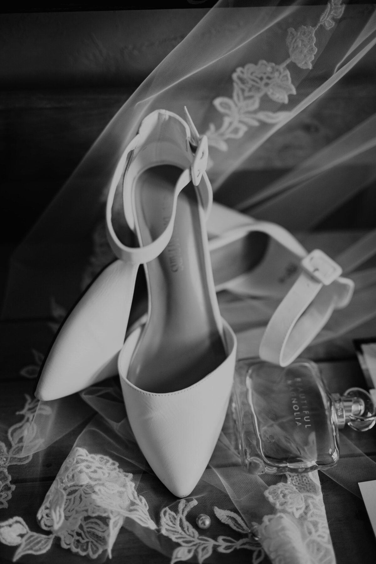 wedding details of brides shoe in black and white, wedding photography in texas