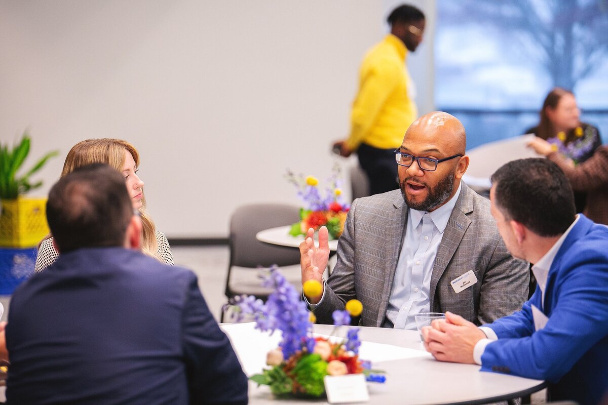 a-group-of-professionals-in-business-attire-engaging-in-discussion-and-networking-at-a-corporate-event-in-fishers-indiana