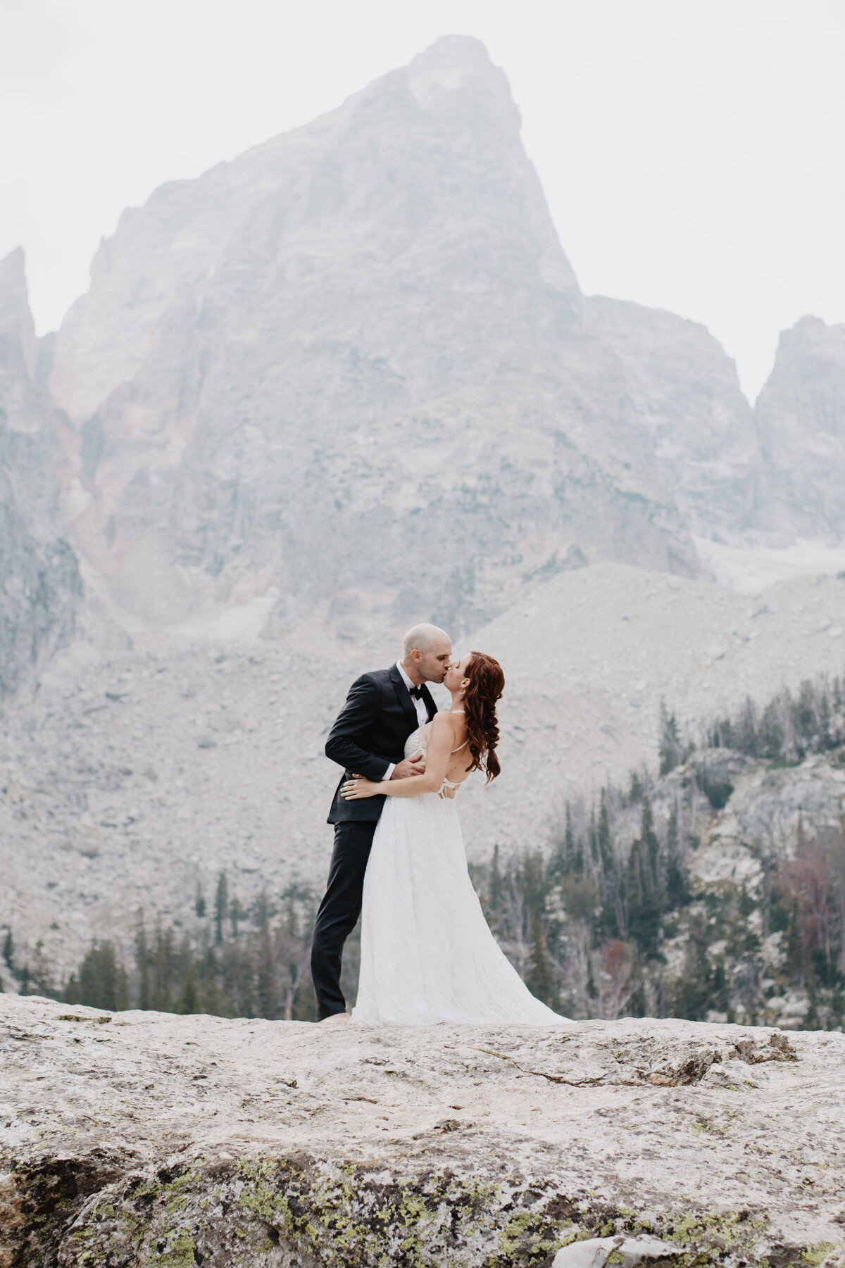 Jackson Hole photographers capture couple kissing as bride and groom
