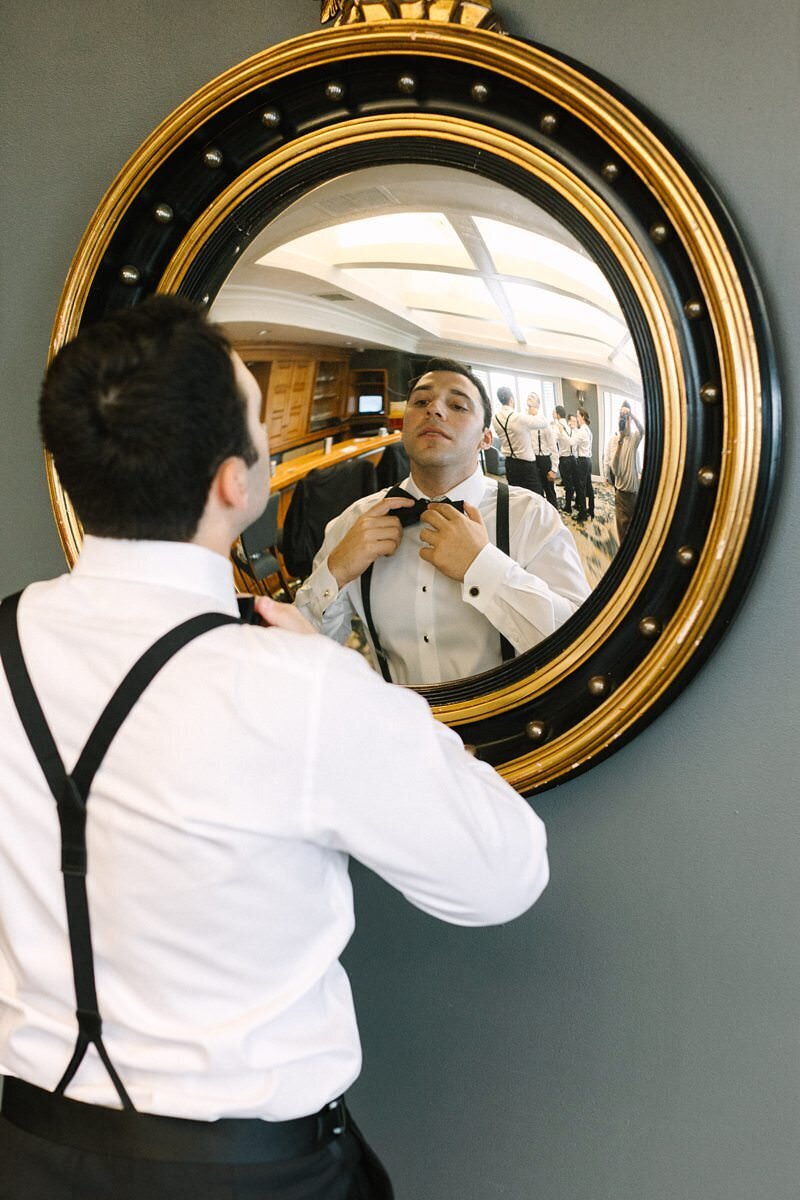 groom-buttoning-suit-jacket-evansville-country-club11