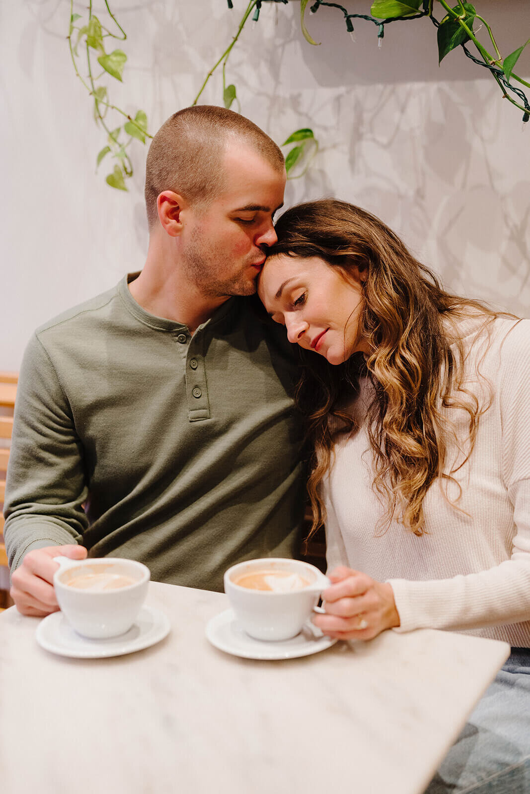 Man kissing woman on the head at Finger Lakes engagement session