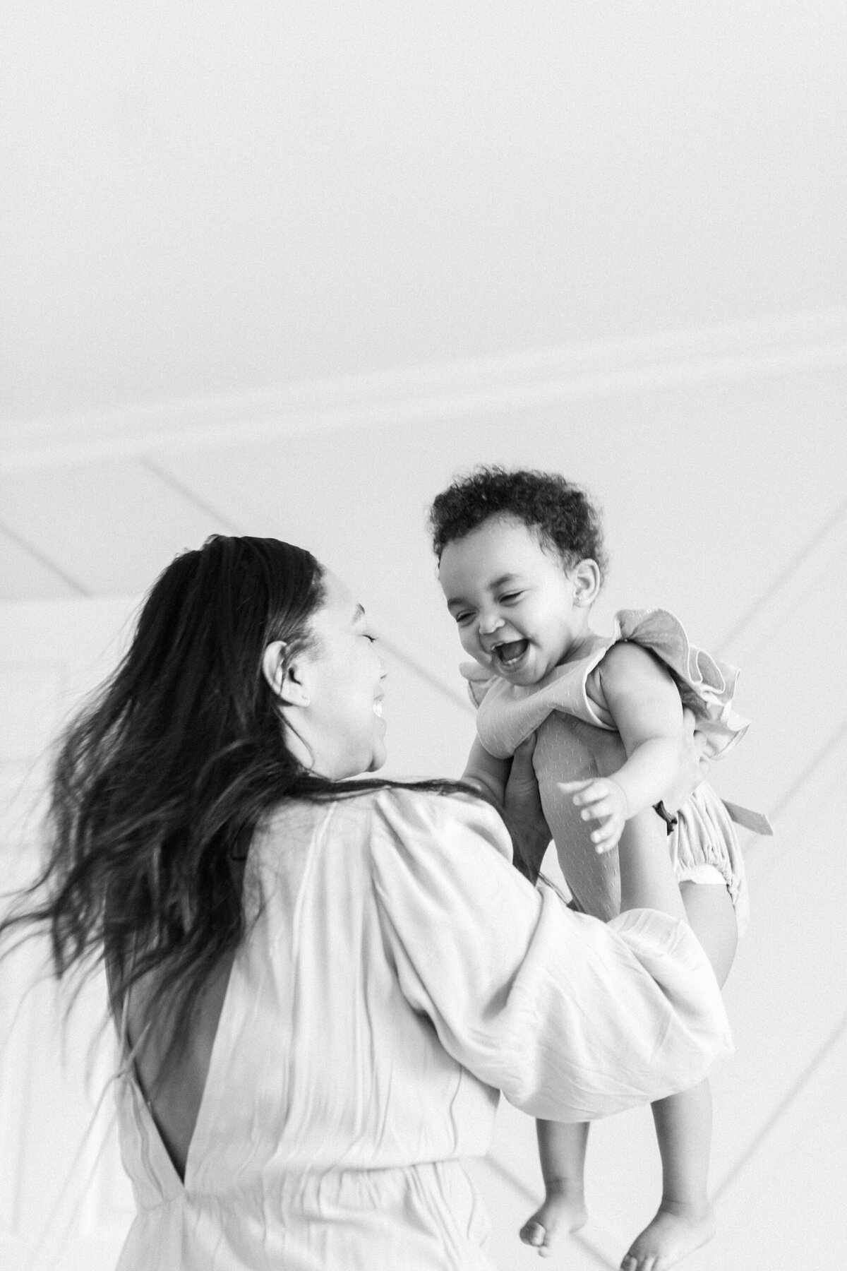 mom and daughter laughing in black and white