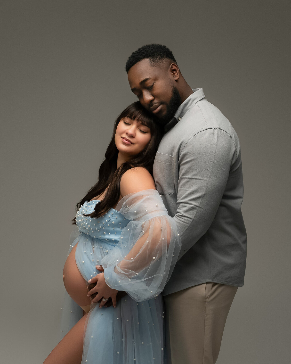 Tender maternity couple moment captured by Austin maternity photographer with professional styling
