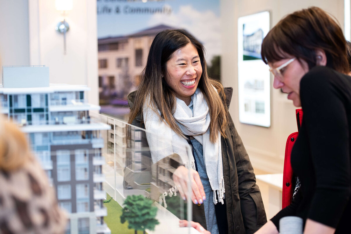 Ottawa event photography showing guests of the eQ groundbreaking event looking at model home plans.  Captured by JEMMAN Photography COMMERCIAL