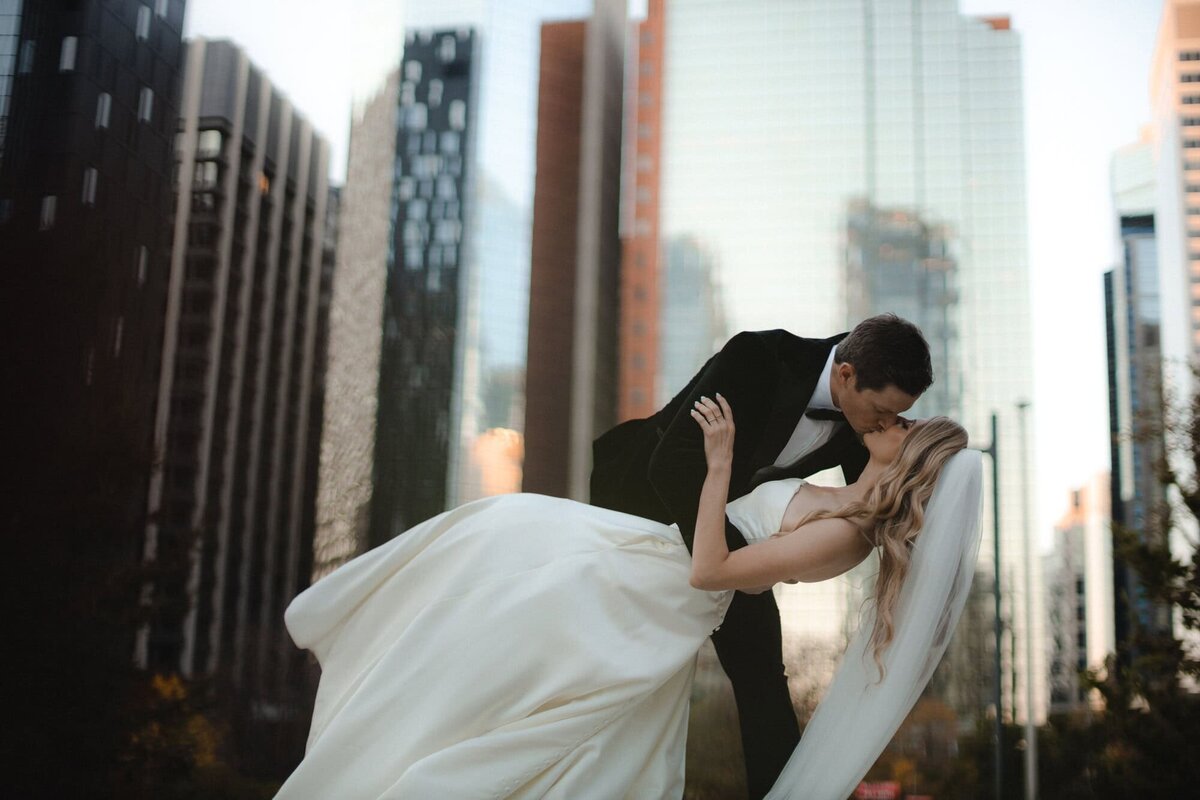 Wedding couple kiss and dip in downtown Calgary Alberta