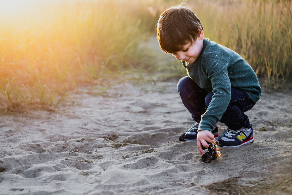 Golden hour photoshoot, showcasing a little boy and favorite trucks.