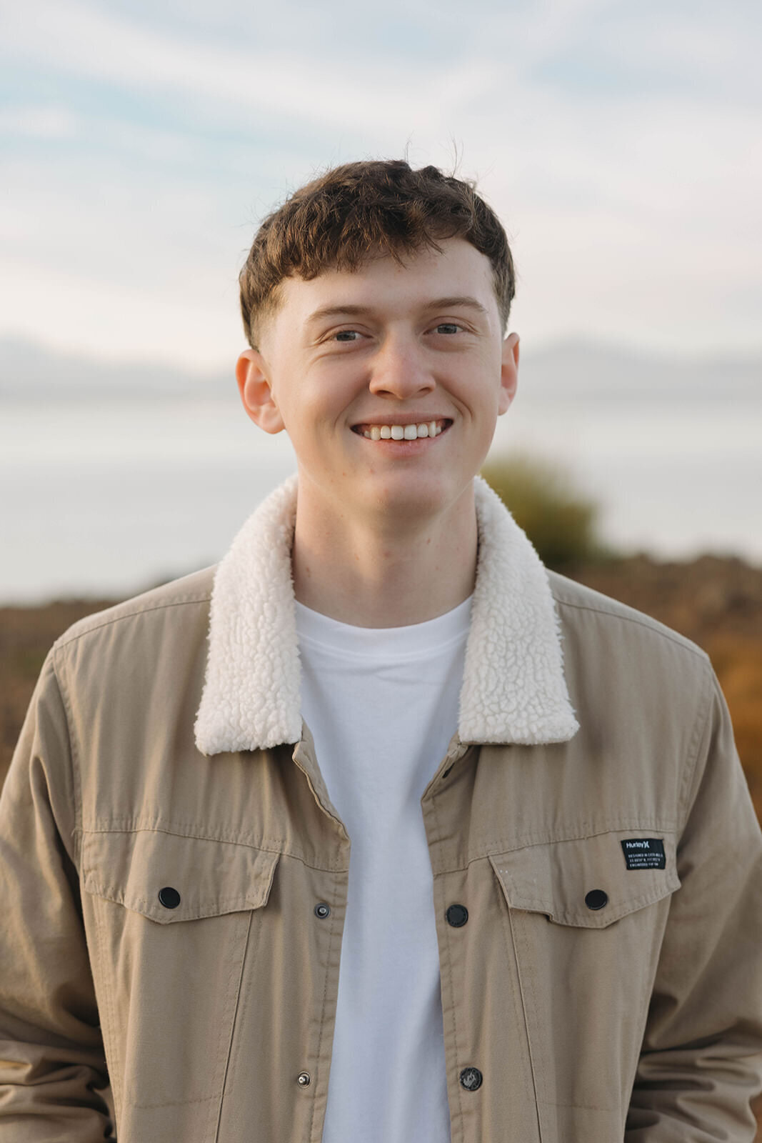 Senior guy laughing by Lake Almanor