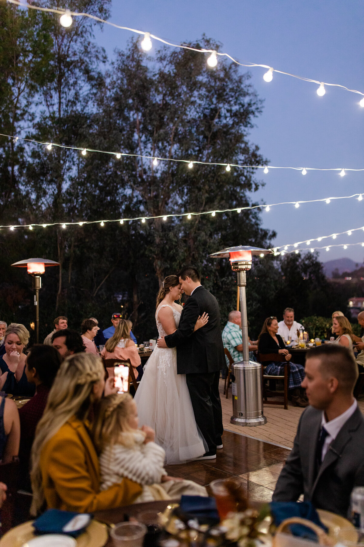 bride and groom hold eachother during their first dance