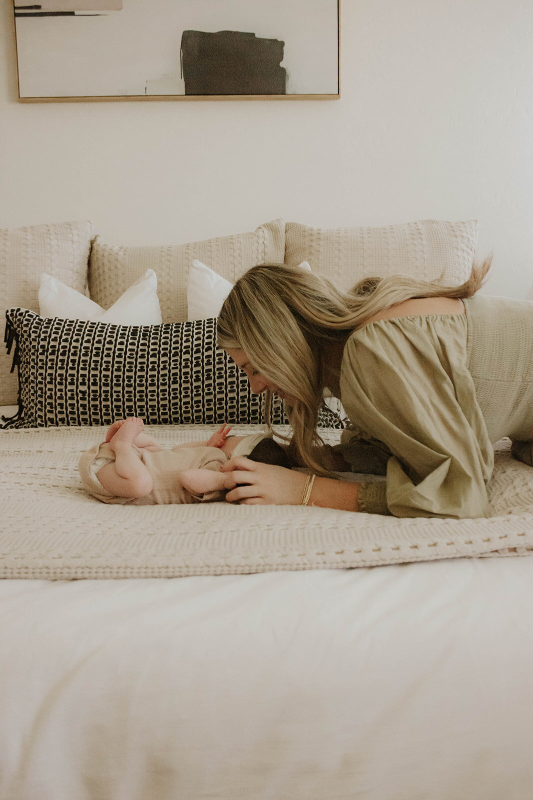 mom leaning over her newborn