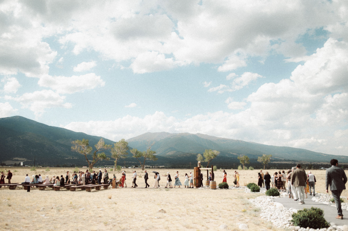 wedding guests walking to the ceremony at The Barn At Sunset Ranch in Buena Vista Colorado