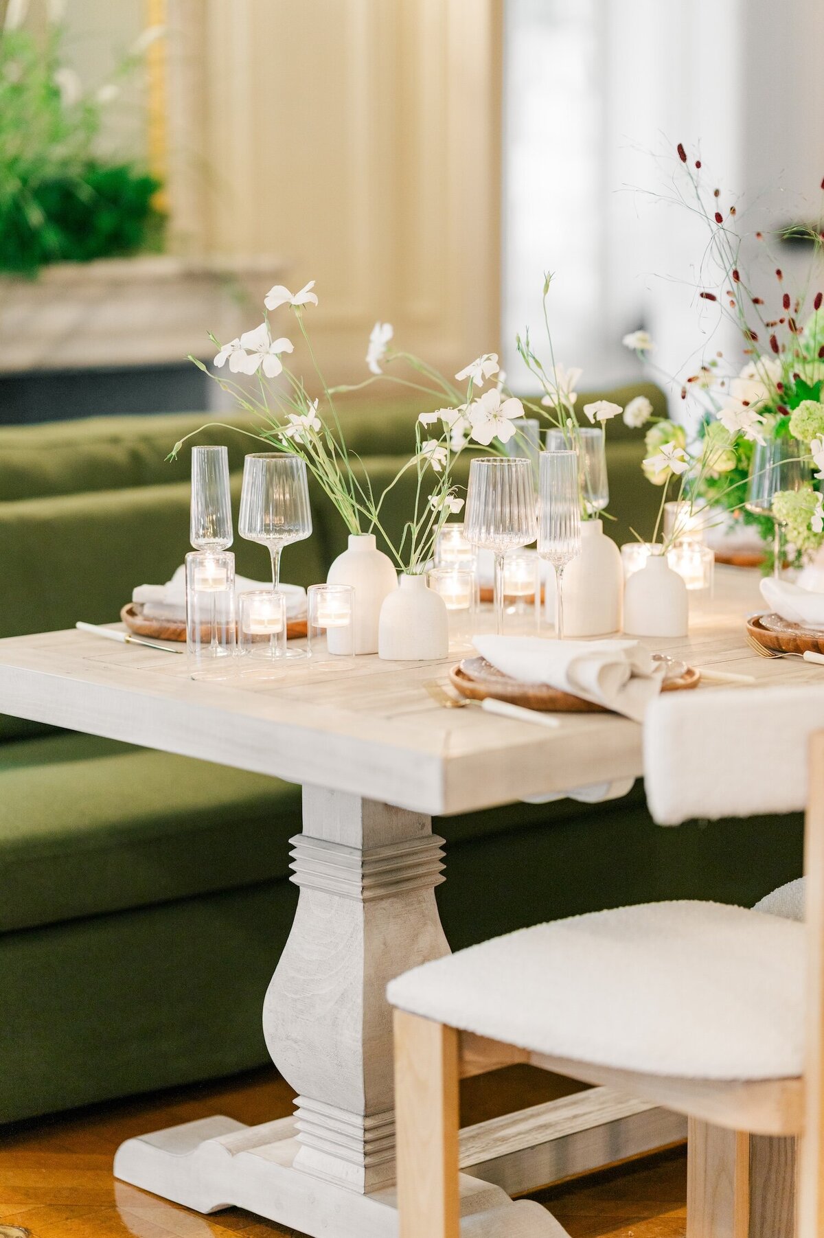 A tan table with rented glasses and tableware that is chic and modern. 