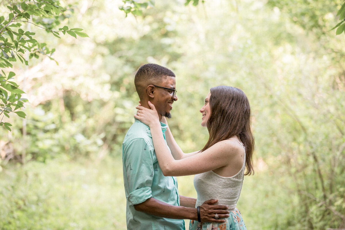 A couple smile adoringly at each other just after their proposal.  Photographed by Colorado Photographer Stephanie Eddy.