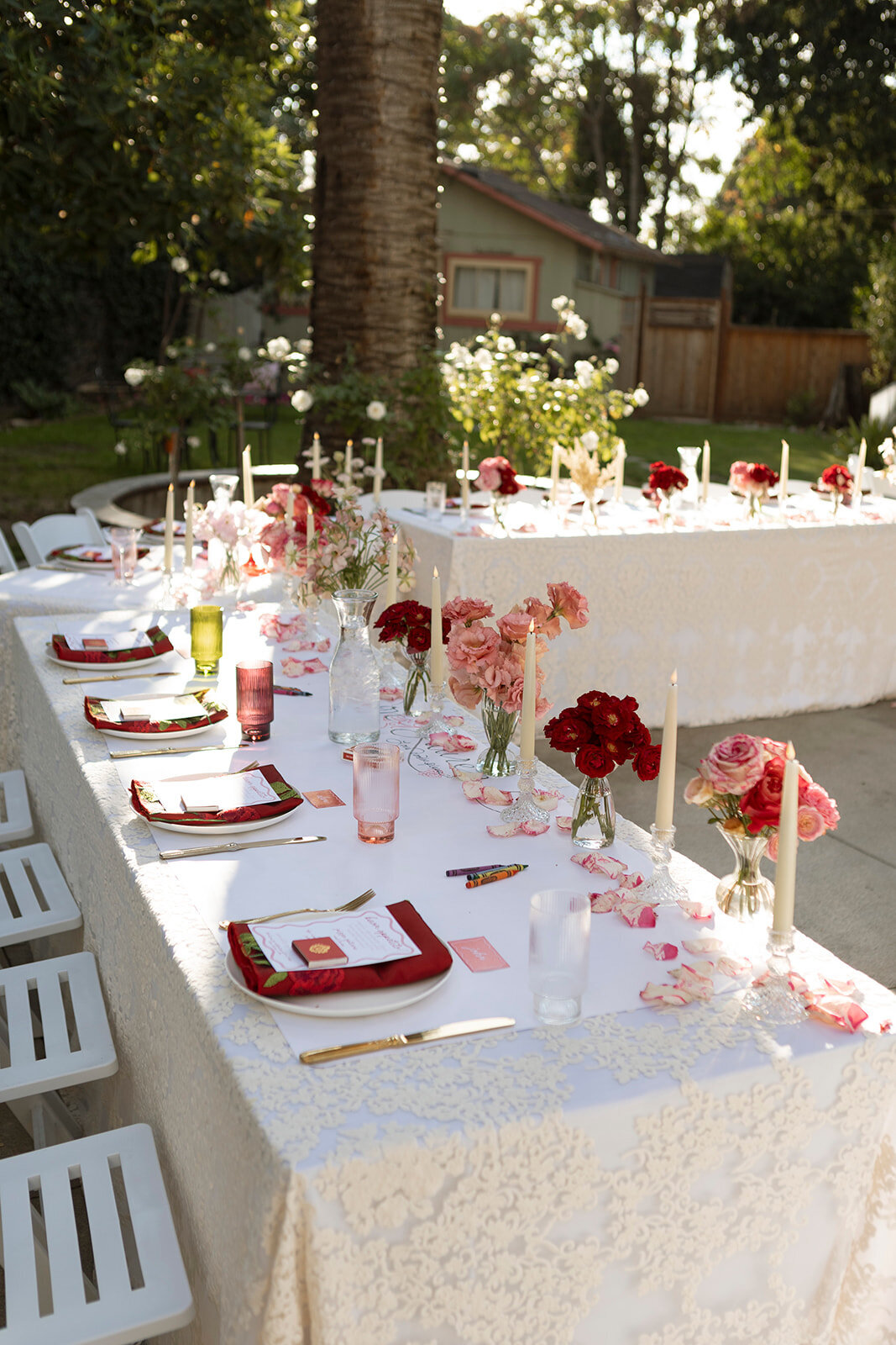 headtable with lace linens and red florals at wedding venue 