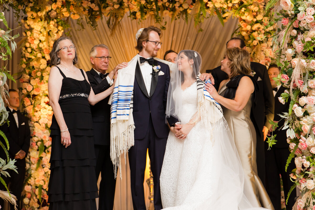 Jewish couple celebrates their marriage under a wedding Chuppah in Columbus Ohio