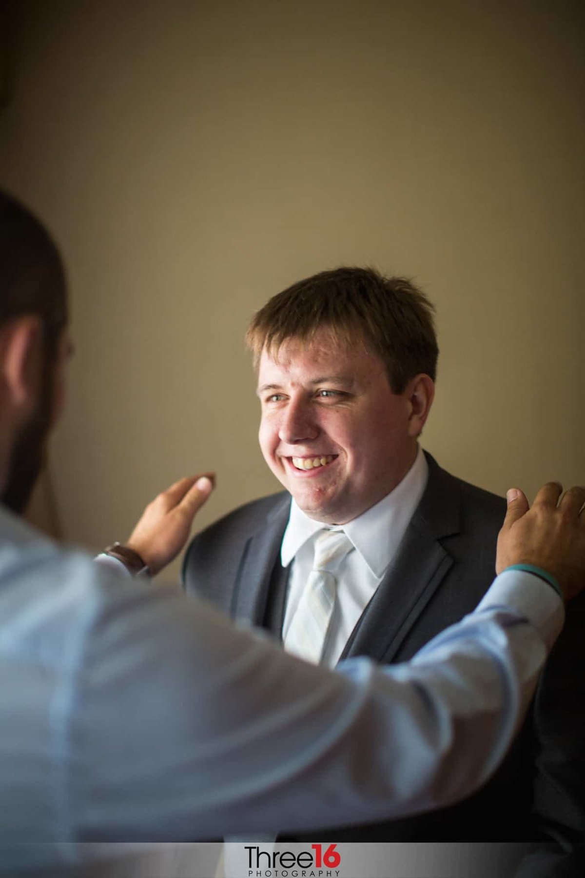 Best Man gives smiling Groom a pep talk
