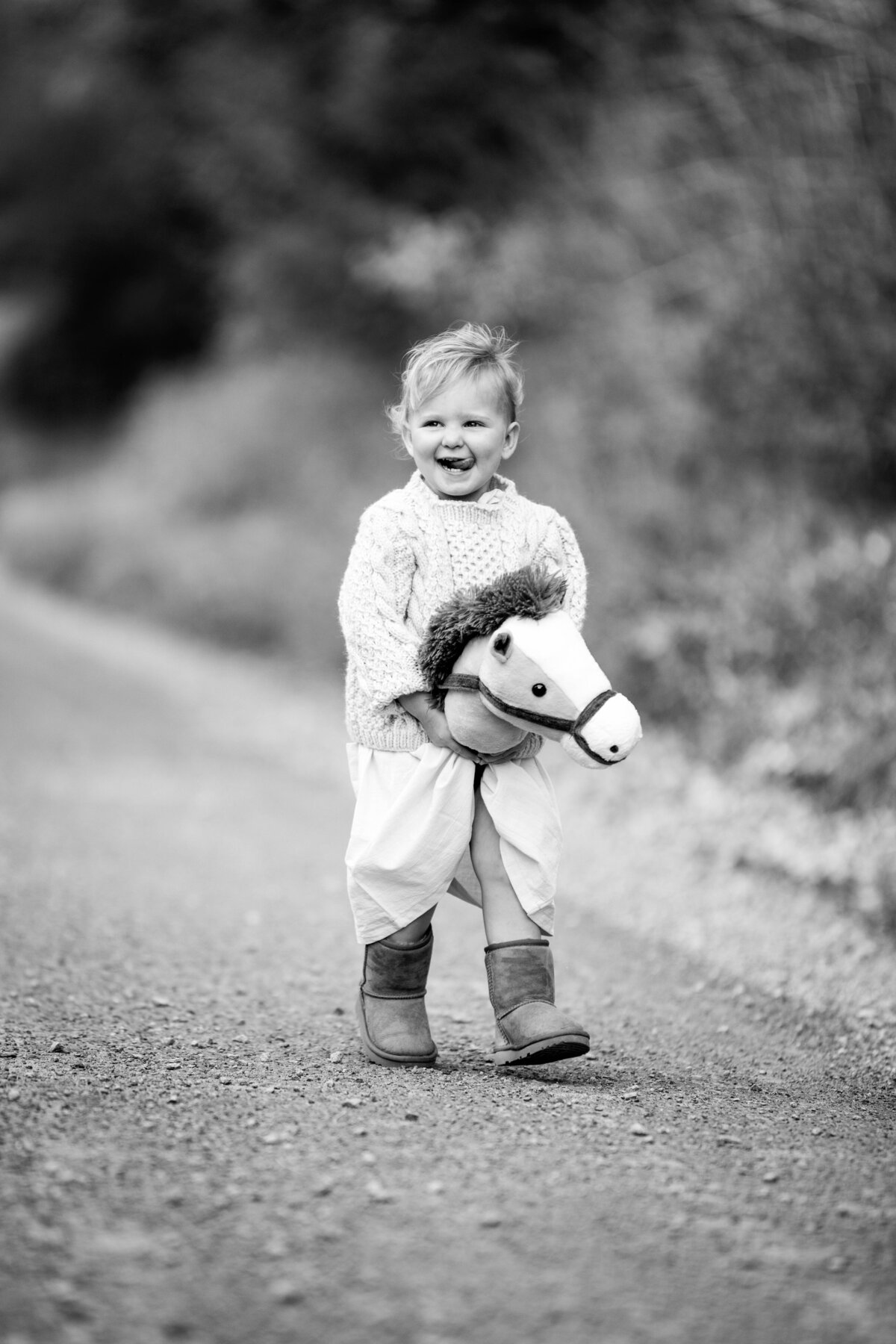Child laughing with toy horse