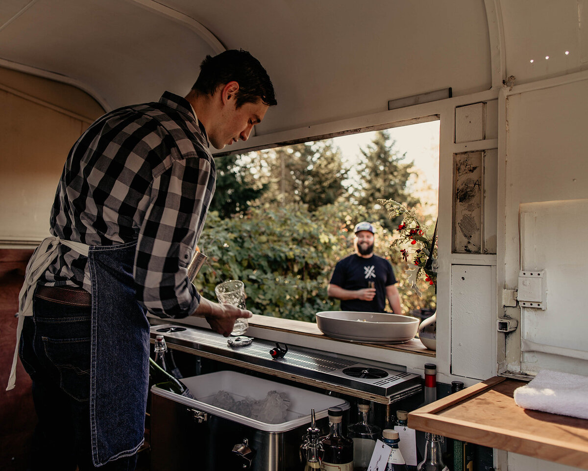 view inside the trailer as the bartender makes a drink