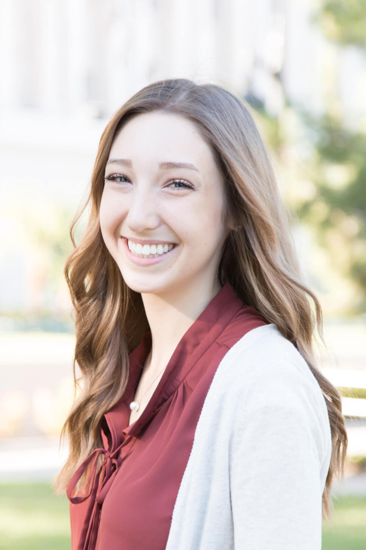 Brightly lit portrait of a beautiful smiling young woman