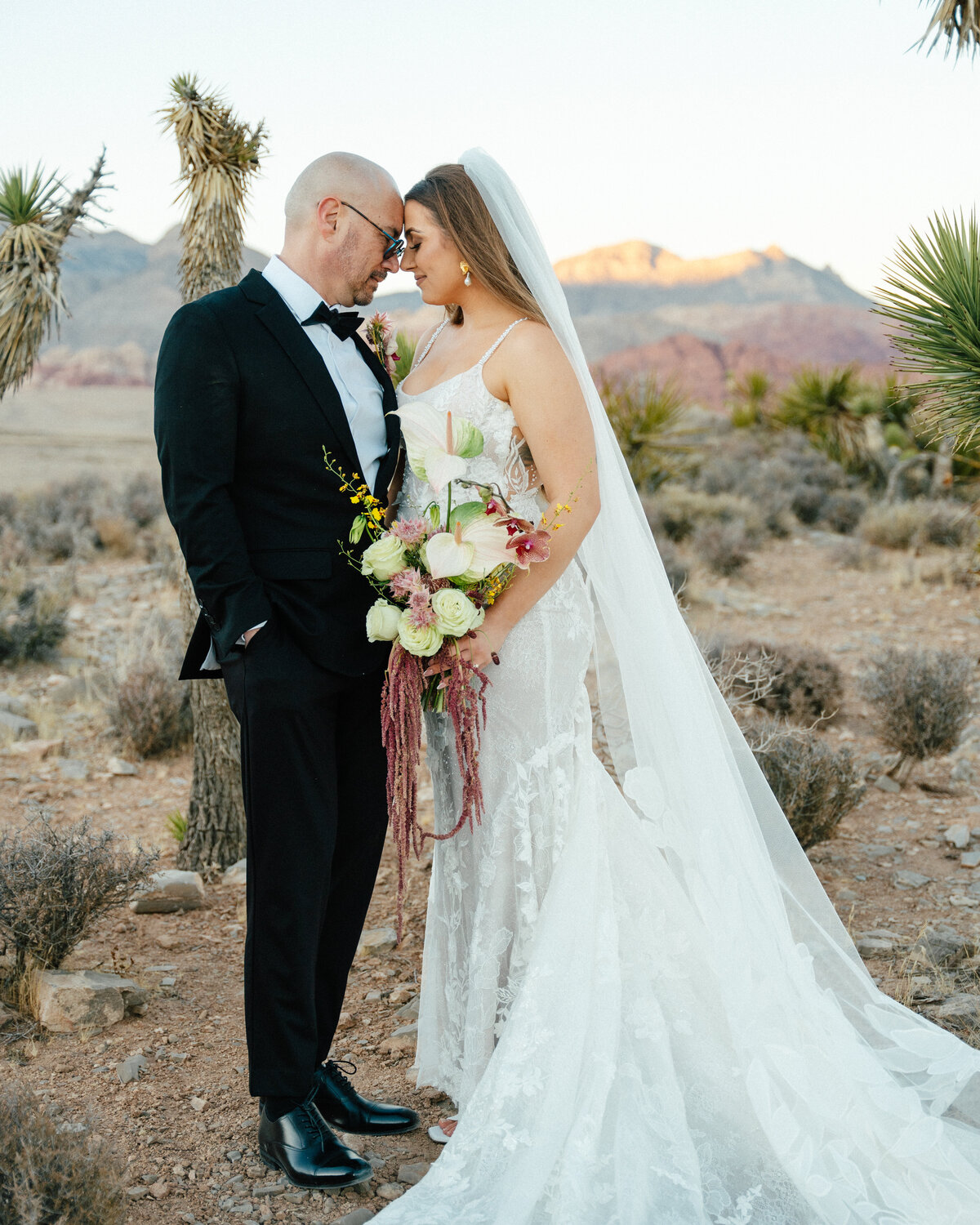 bride and groom touching foreheads in red rock canyon just outside of las vegas, nv