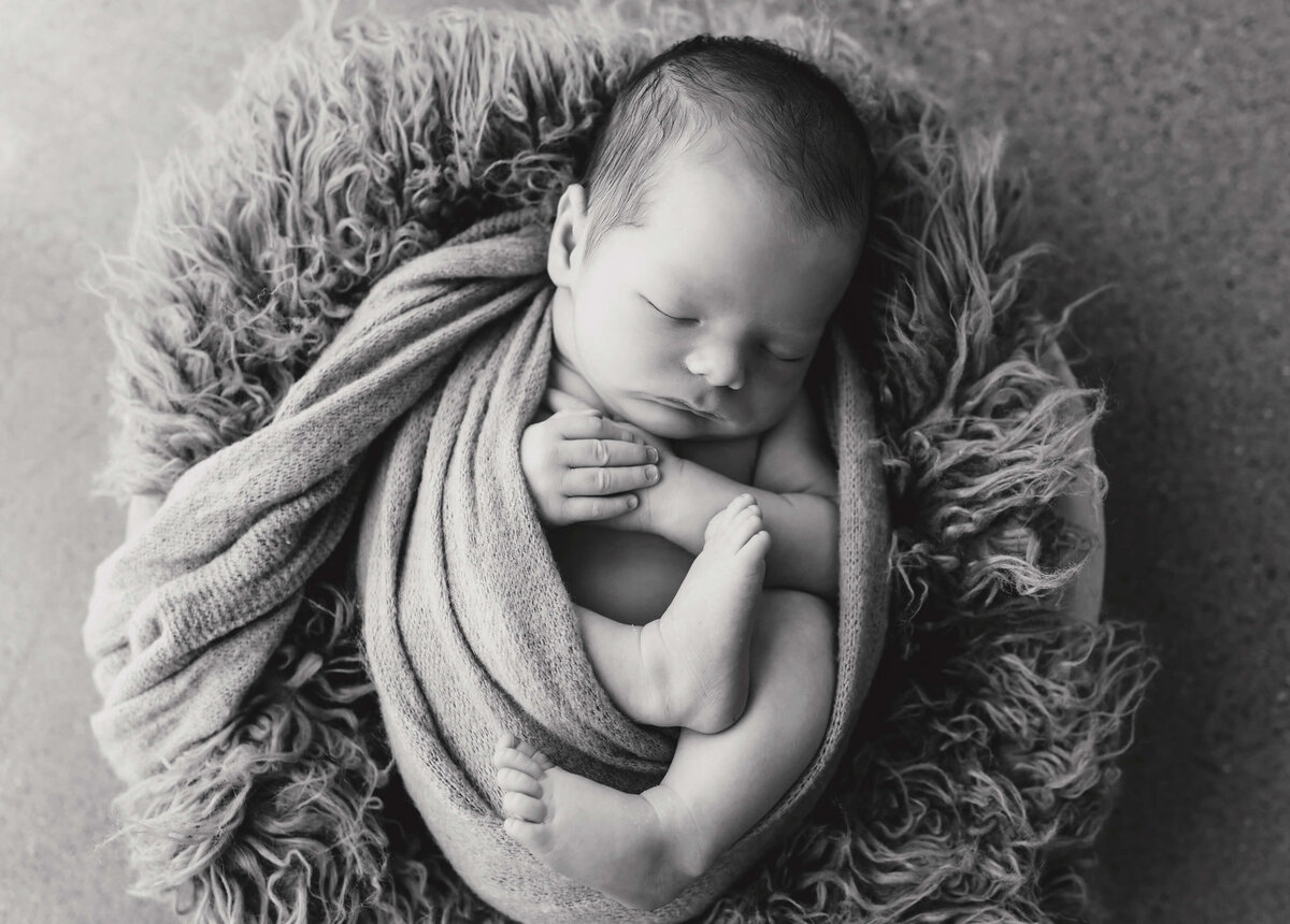 black-and-white-image-of-newborn-swaddled-in-wrap