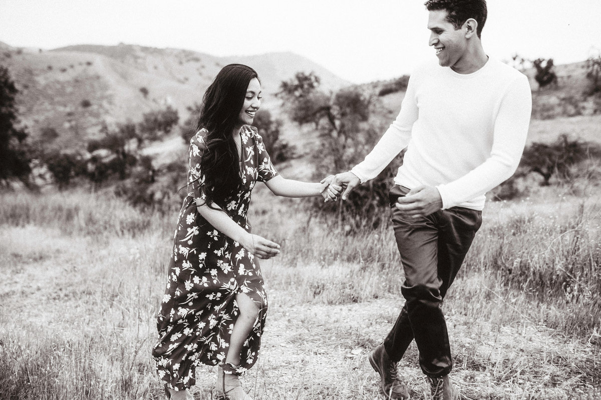 Engagement Photograph Of  Man And Woman Holding Hands While Walking Los Angeles