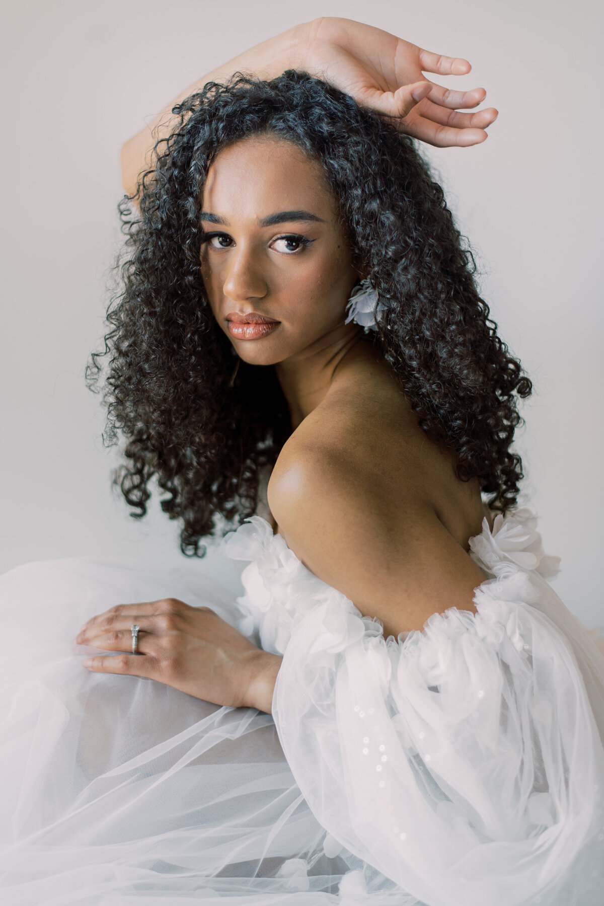 The bride’s elegant hand adorned with a sparkling engagement ring, captured in a soft, romantic moment by Christine Grace Photography in Toronto.
