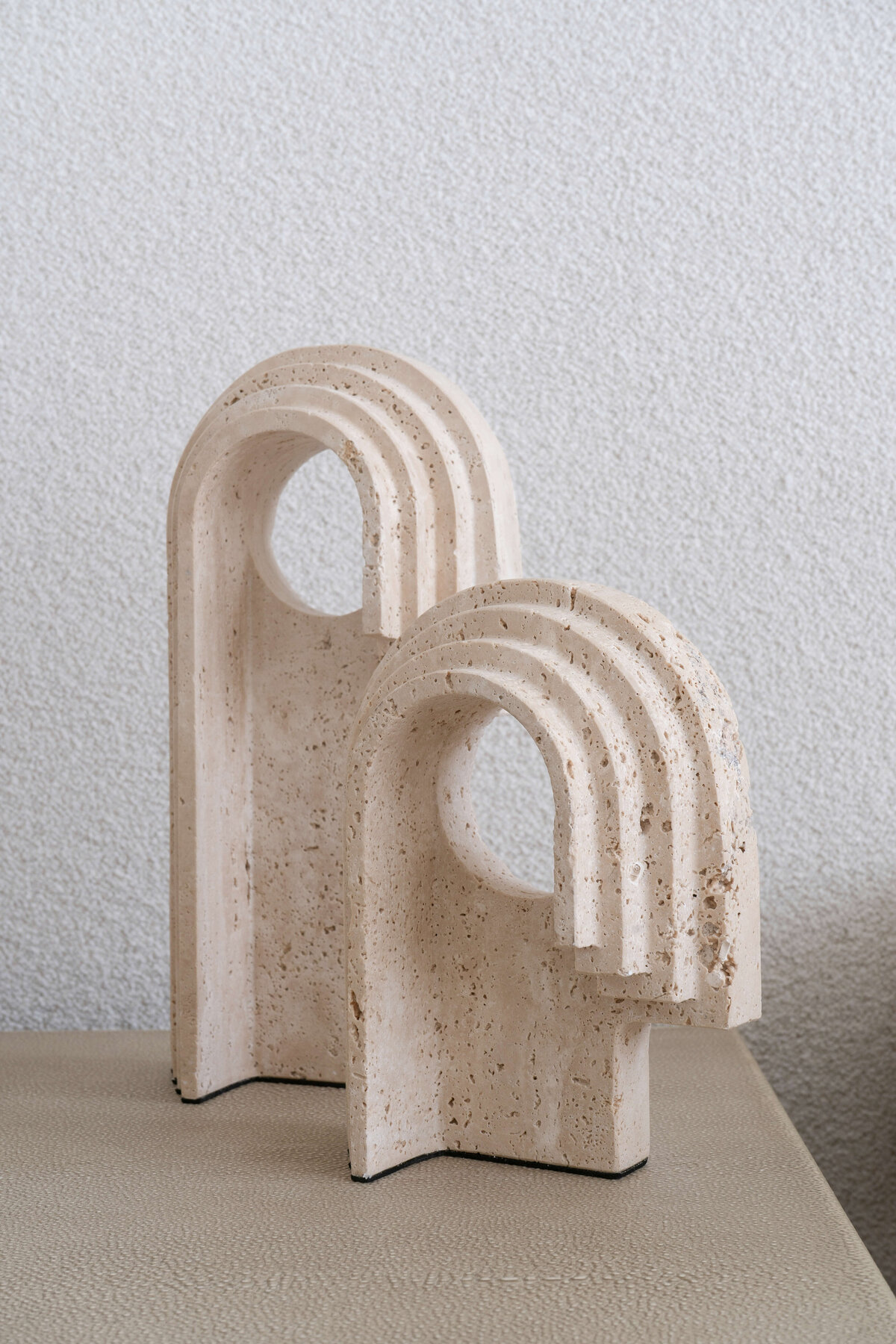 A neutral stone accessory on top of a bedside table in the primary bedroom. The piece highlights the light, airy, neutral feel of the room.