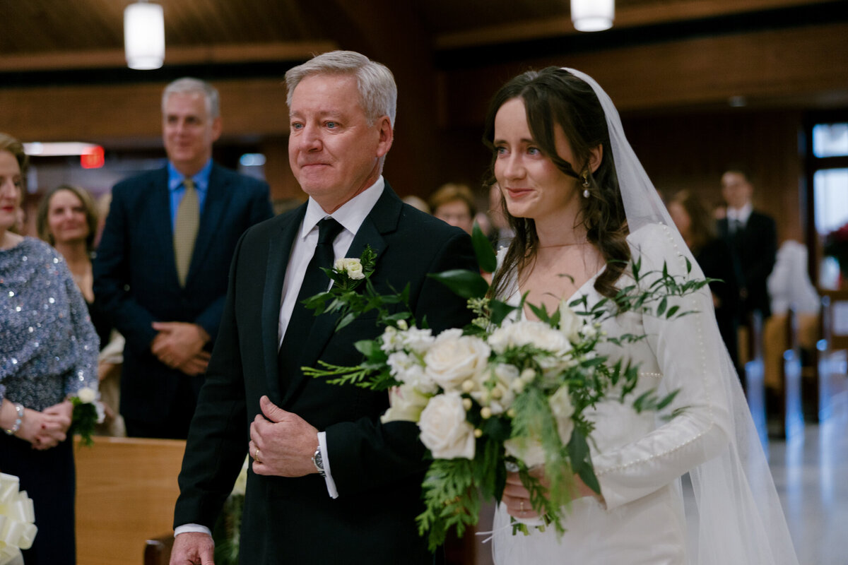 Emotional image of father walking his daughter down the isle on her wedding day