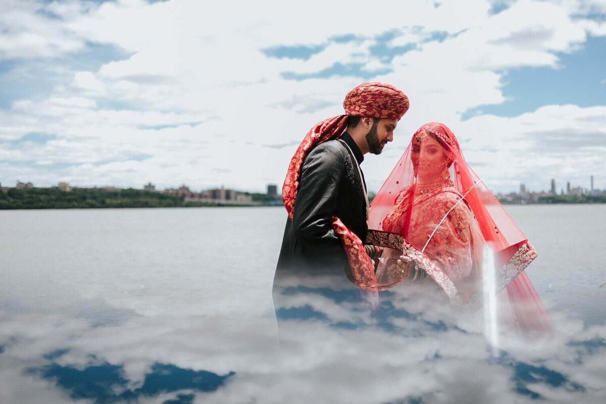 Bride and groom during portraits under the veil. The bride is smiling and looking to the side while the groom is looking at his bride-to-be