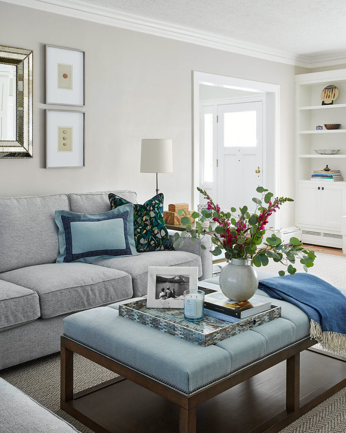 Living room with grey couch and light blue accents