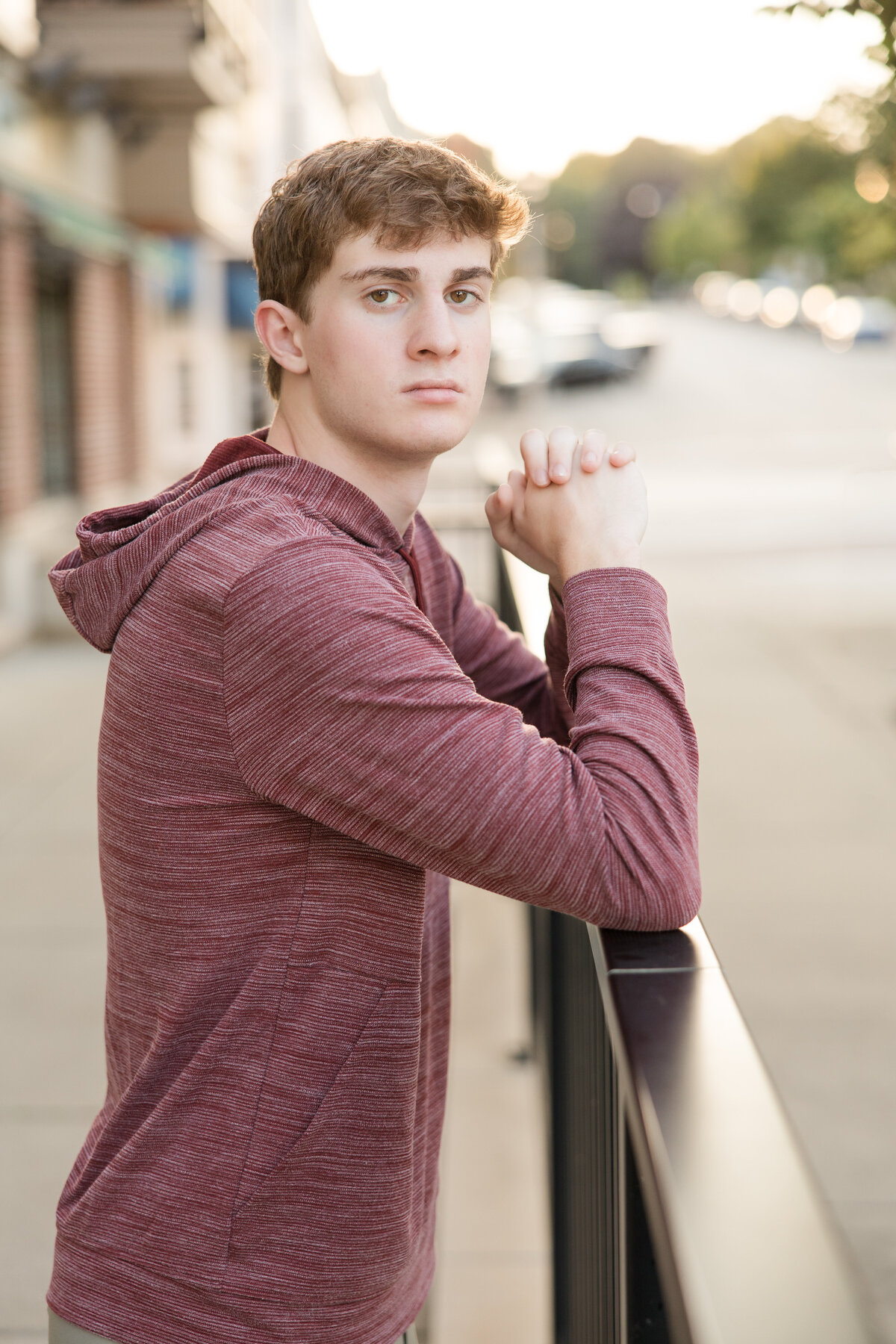 Senior guy leaning against a rail, looking at the camera