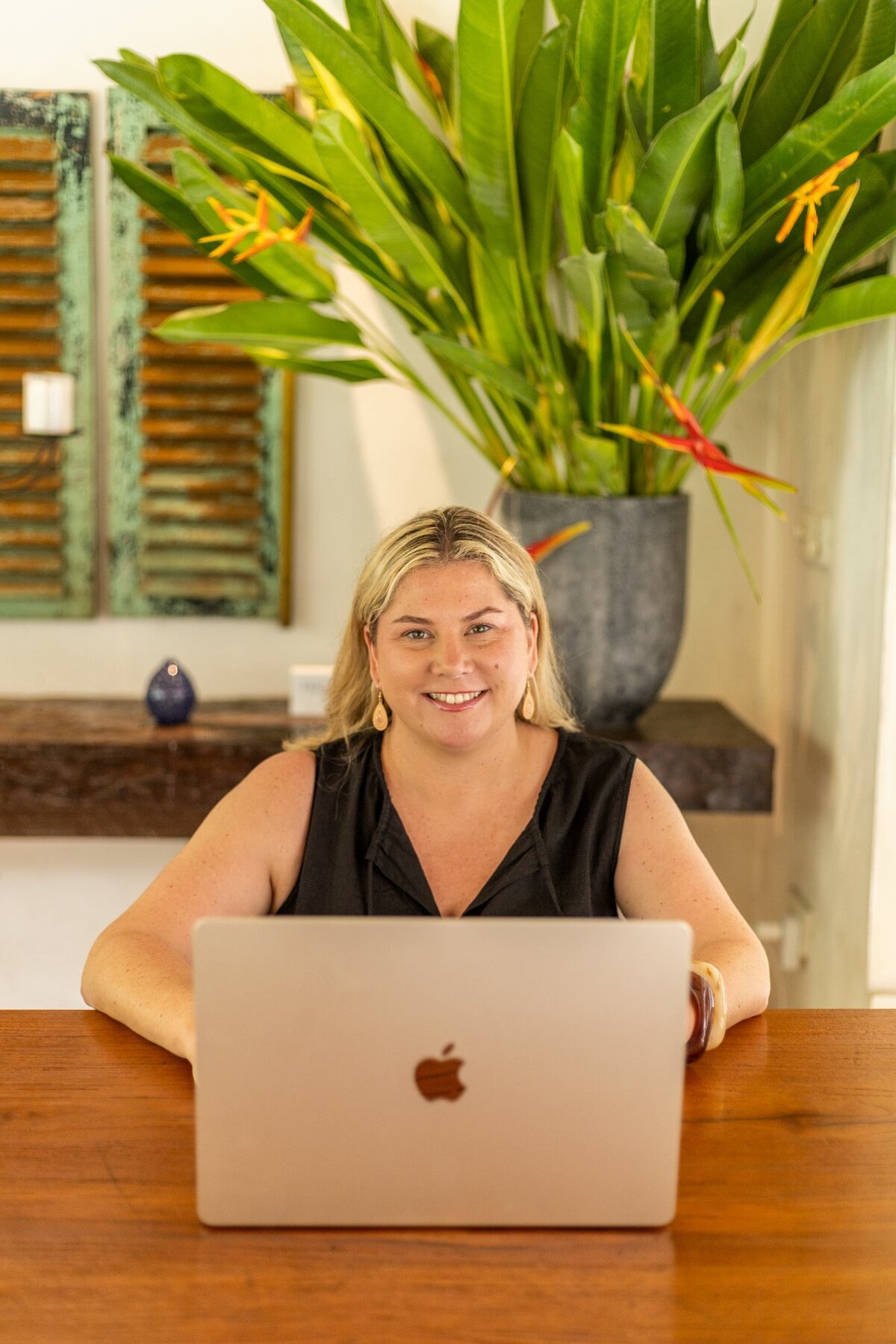 Renee Firth, founder of ASD Mum Club, smiling at her laptop