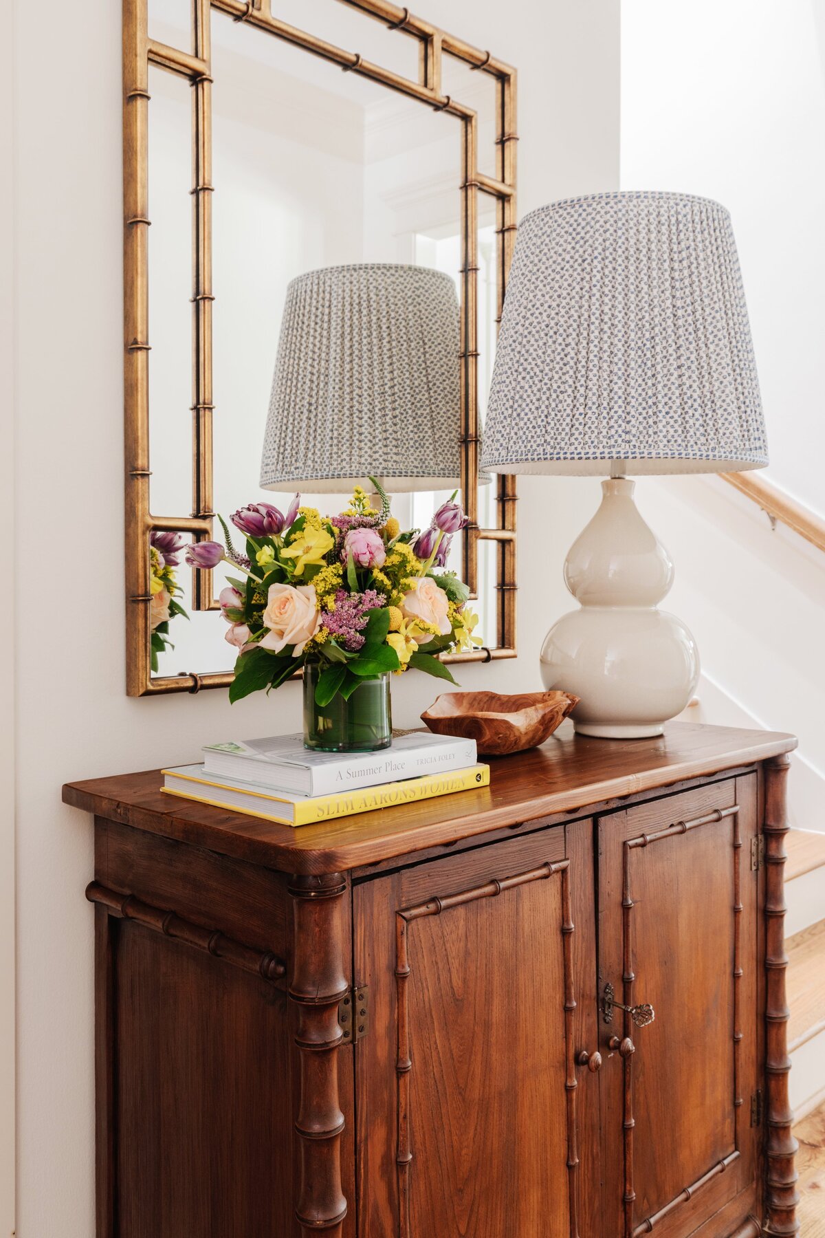 oyster creek studios oak forest remodel wooden accent table with white lamp and mirror near stairs