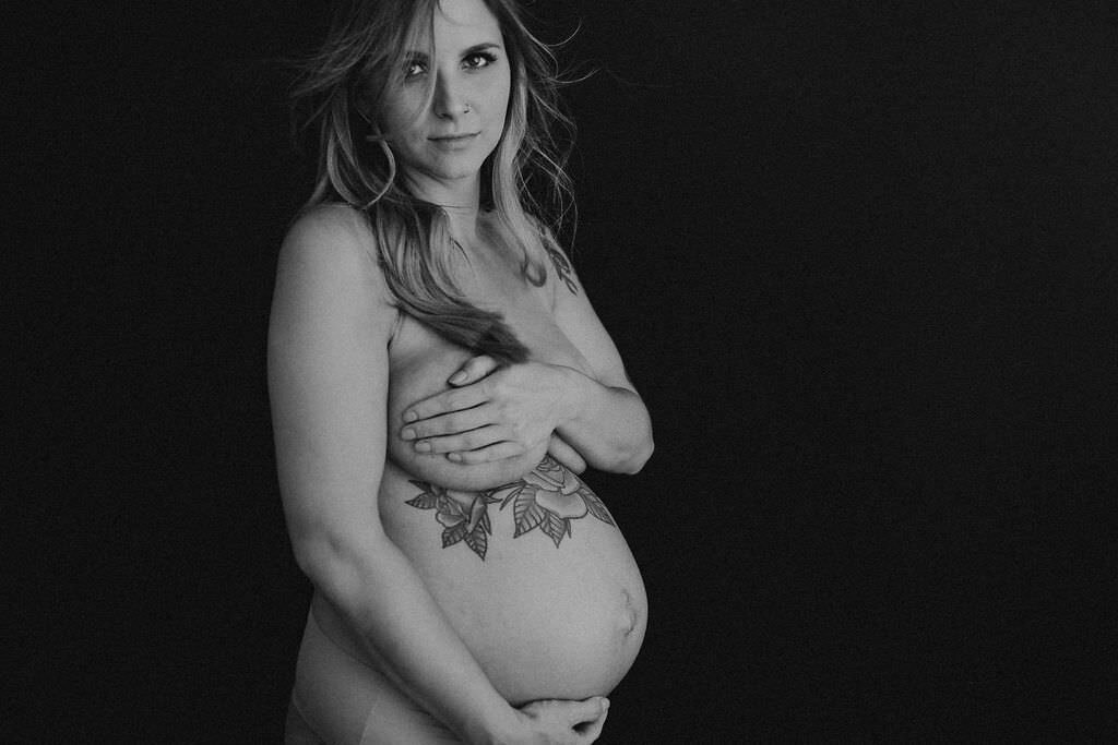 black and white image pregnant woman posing