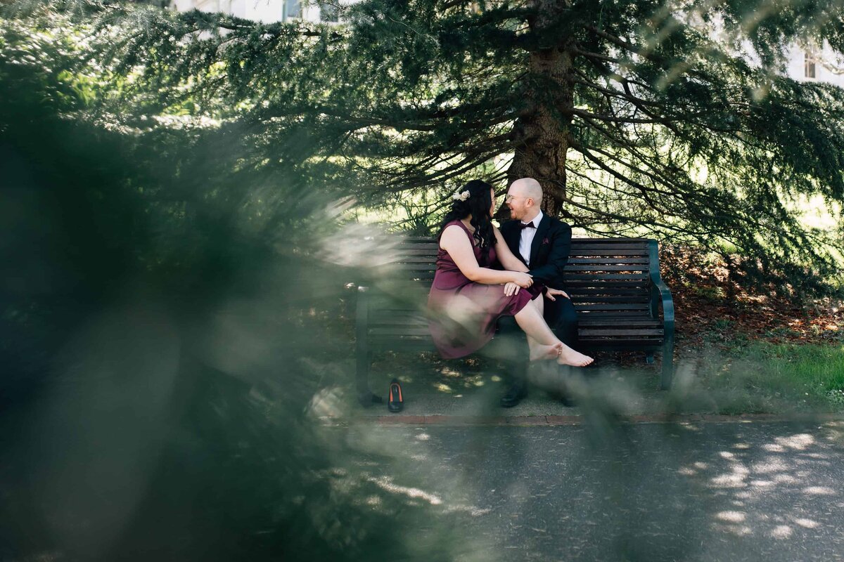 Couple sitting on park bench, couple photoshoot Melbourne