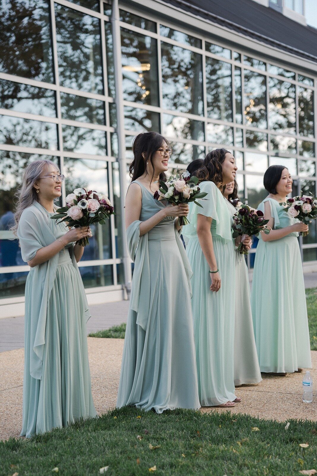 Wedding party in a light green dress holding their bouquet