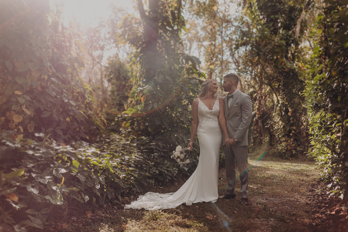 Tampa wedding photo + film storytelling — bride and groom at sunset at Bakers Ranch venue.