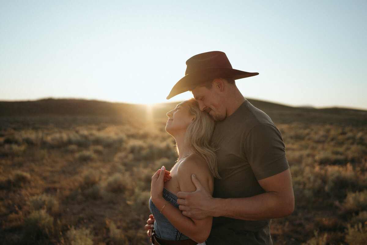 Couple during golden hour engagement shoot in Idaho wedding/elopement - photographed by The Storytellers