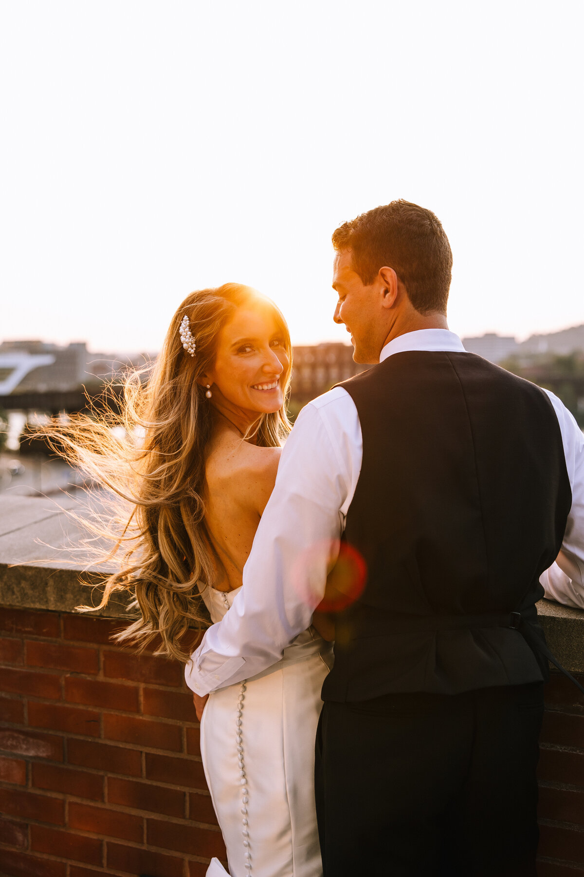 Bride and groom on the Heinz History Center rooftop at sunset.