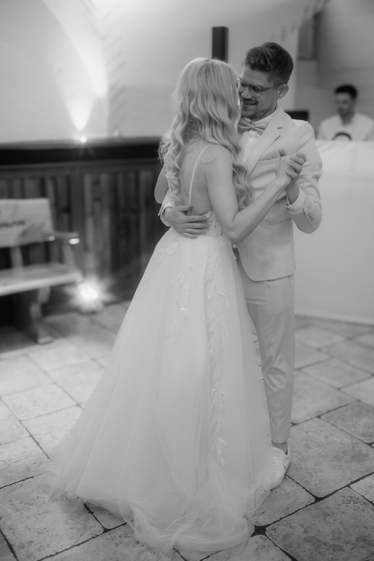 Dancing their first dance, the newly weds enjoy a moment of togetherness.