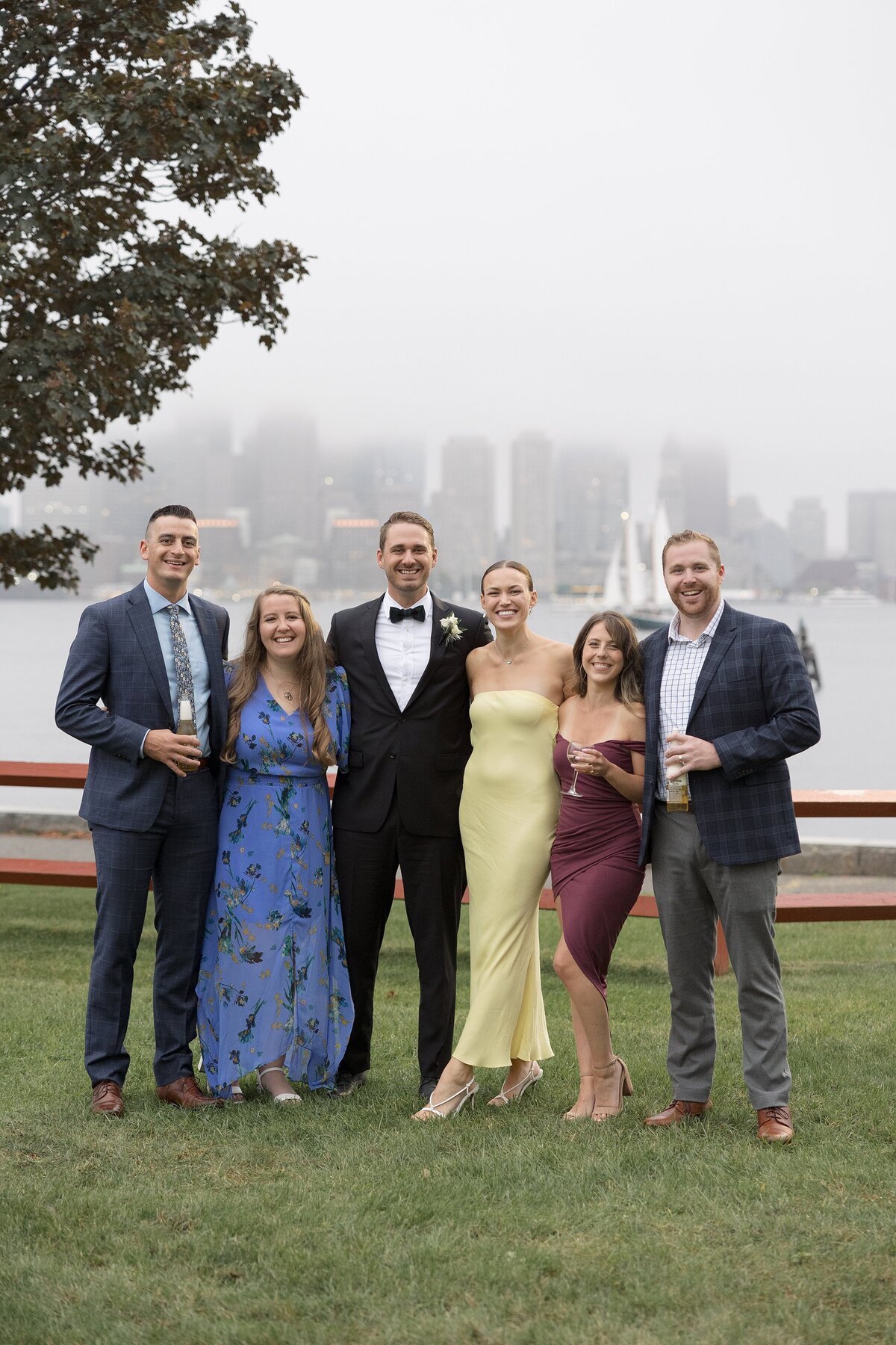 Guests pose for the camera with Boston skyline in the background.