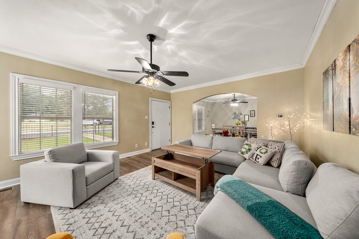 Spacious living room area with coffee table that converts to work space in this five-bedroom, 4-bathroom pet-friendly vacation rental house for 12 guests with free wifi, free parking, hot tub, mother-in-law suite, King beds and updated kitchen in downtown Waco, TX.