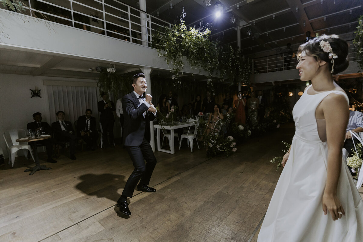 the groom silly dance while the bride smiling at him