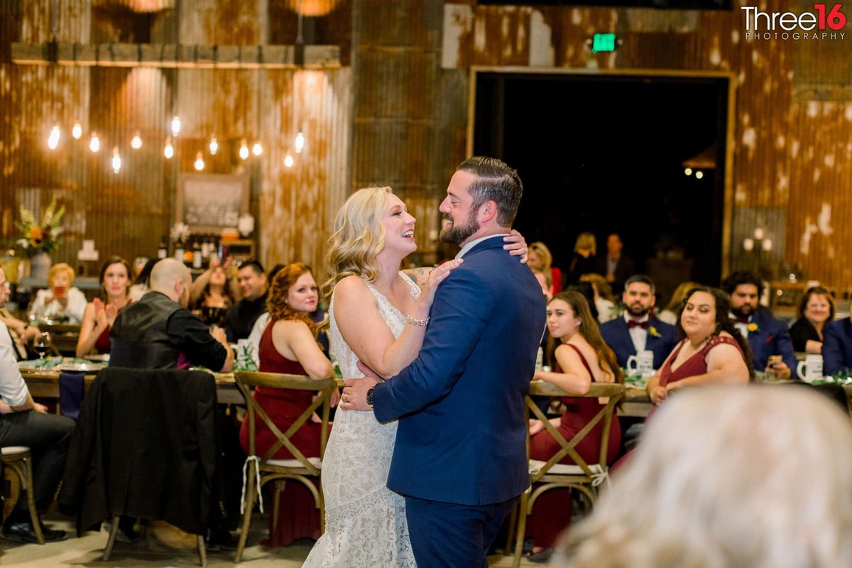 Bride and Groom share their first dance together in front of family and friends