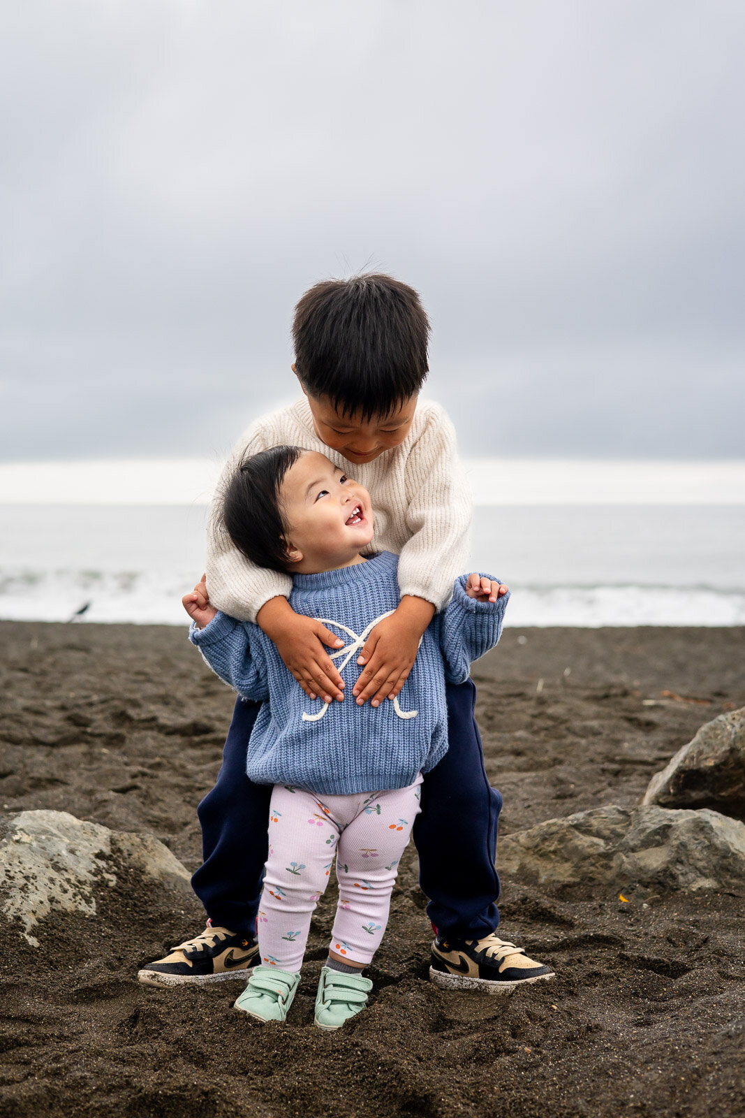 Brother hugging sister with joy during Bay Area school photography lifestyle session – Ellobelle Photography