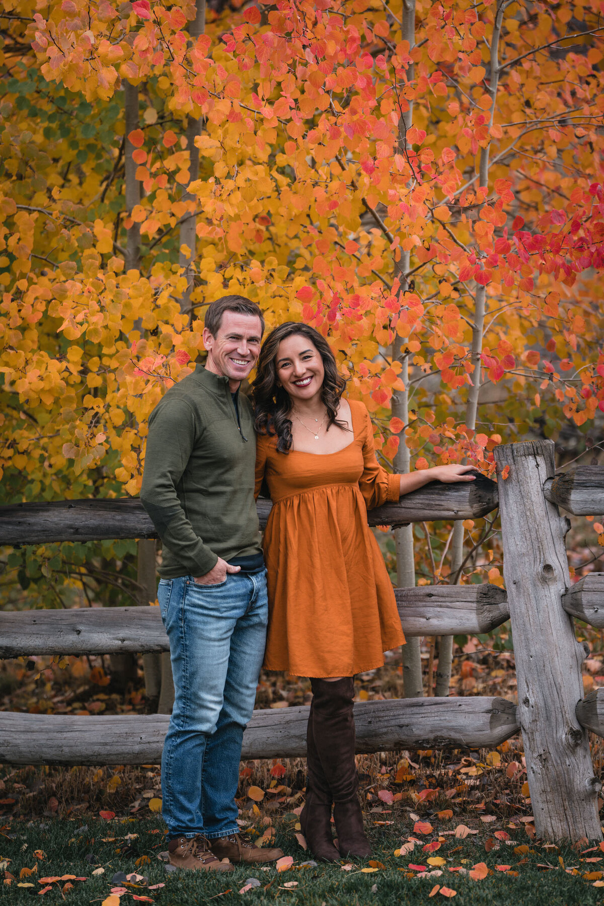 Engaged couple surrounded by fall color in an Aspen mountain landscape