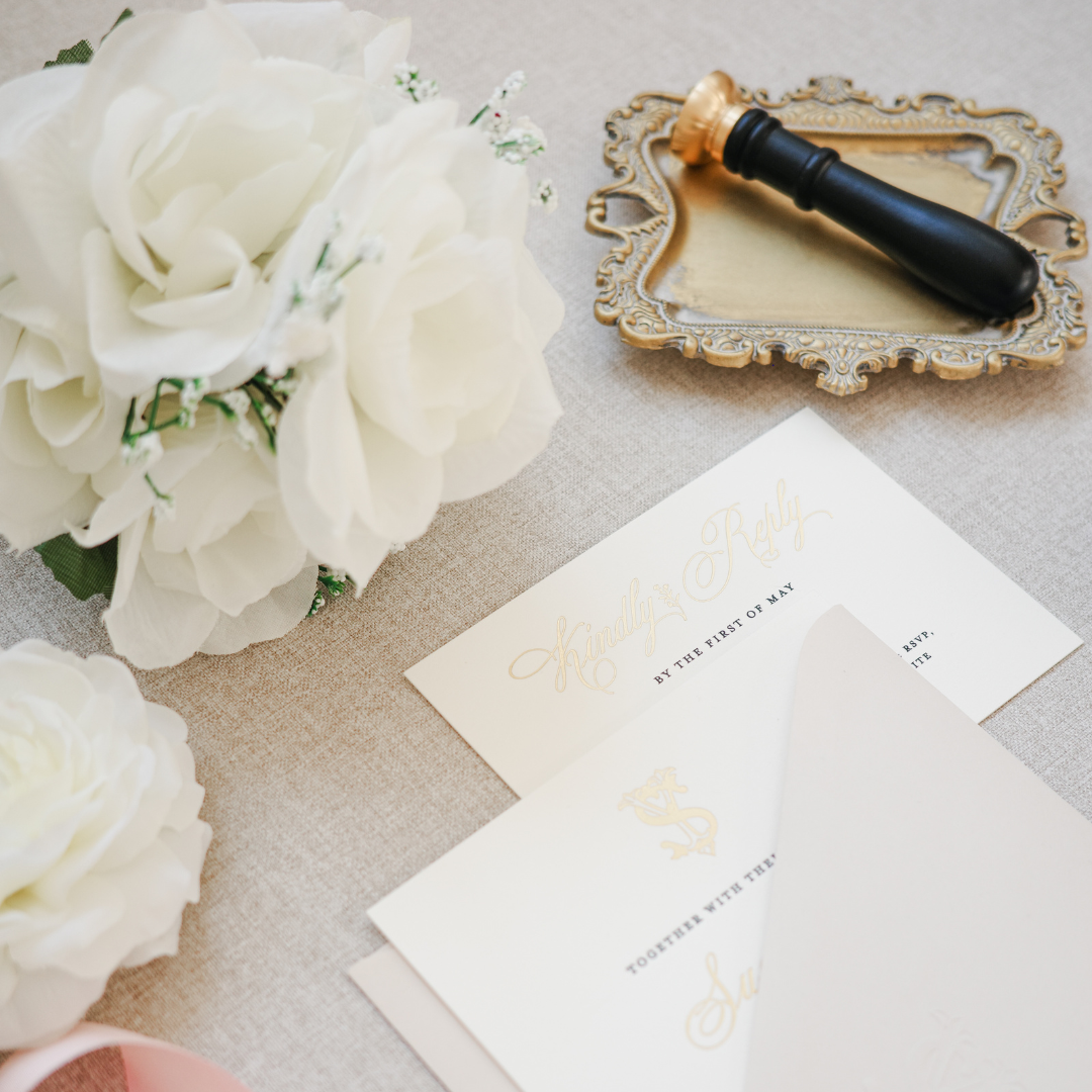 assembled gold foiled wedding invitation with pink envelope