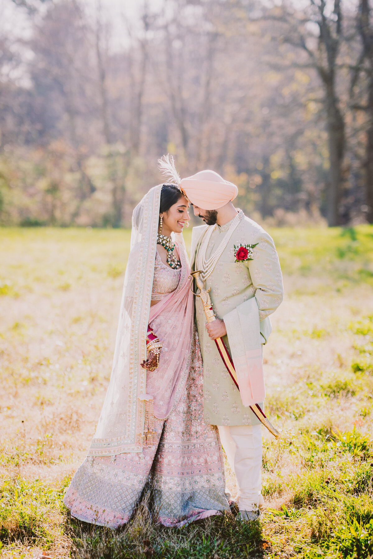 Sikh wedding couple in pink and green outside the glen cove gurudwara in long island ny