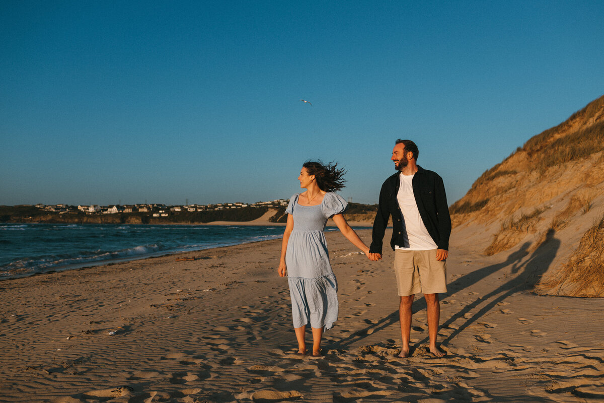 Engagment shoot photo at sunset on the beach in West Cornwall looking acroos to the Hayle Estuary