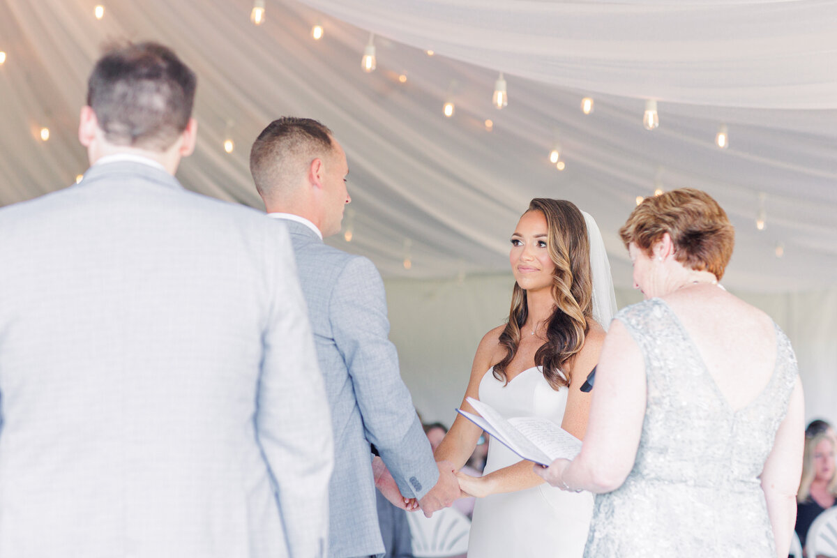 Bride and groom holding hands during a South Shore Country Club wedding ceremony